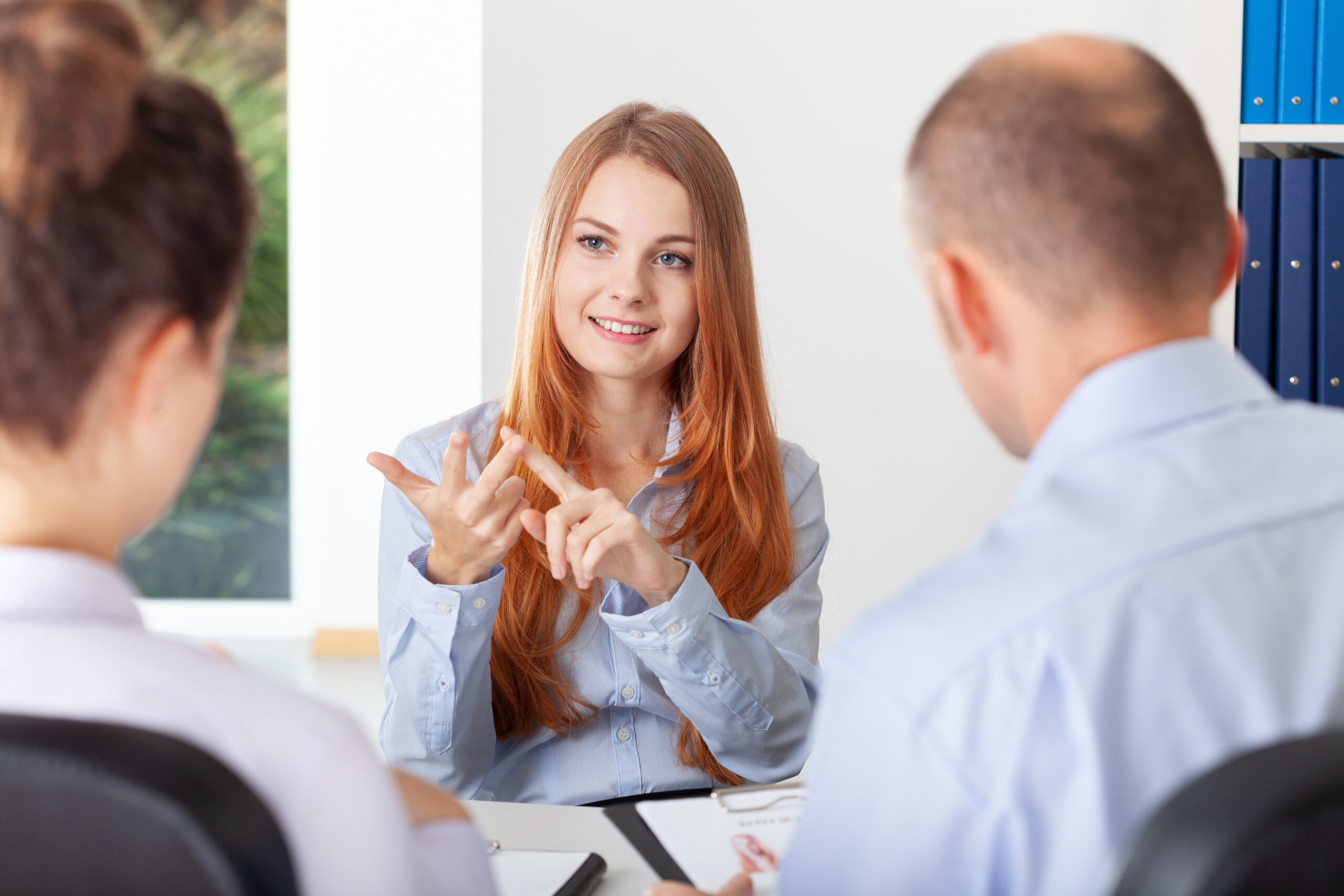 Confident young woman pointing her advantages during the recruitment interview